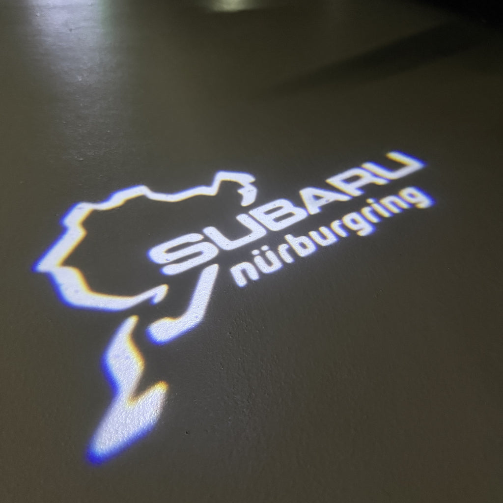 SUBARU ORIGINAL LOGO PROJECROTR LIGHTS (quantity 1 = 1 sets/2 door lights) Nr.03A5