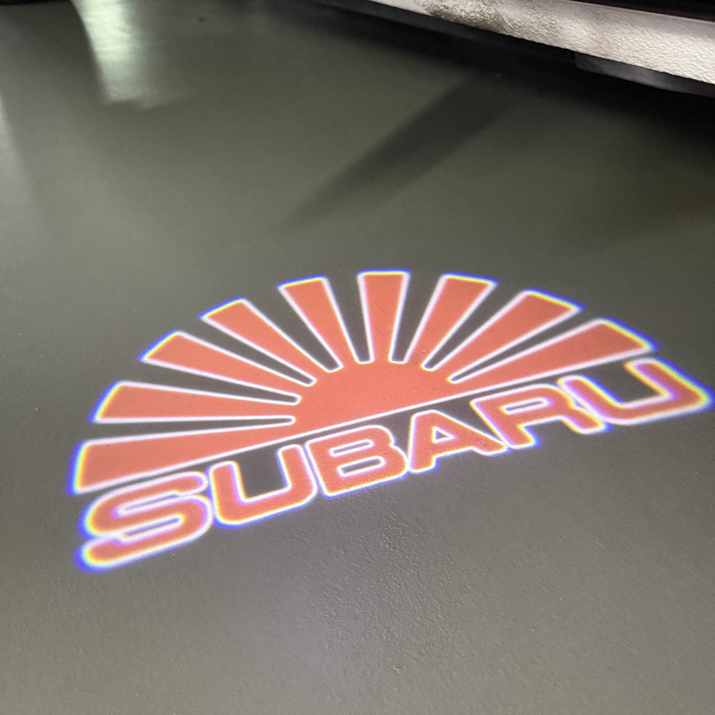 SUBARU ORIGINAL LOGO PROJECROTR LIGHTS (quantity 1 = 1 sets/2 door lights) Nr.7