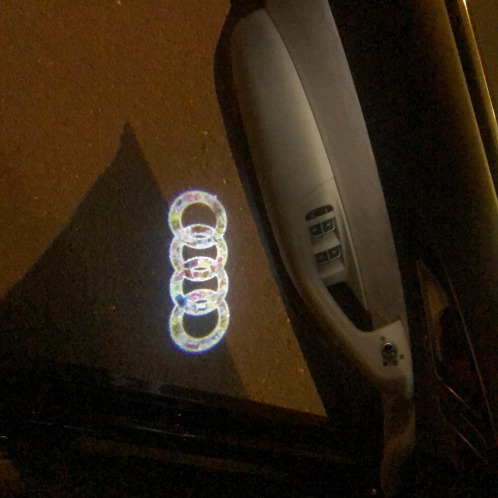 AUDI LOGO PROJECTOT LIGHTS Nr.10 (الكمية 1 = 2 Logo Films /2 أضواء الباب)