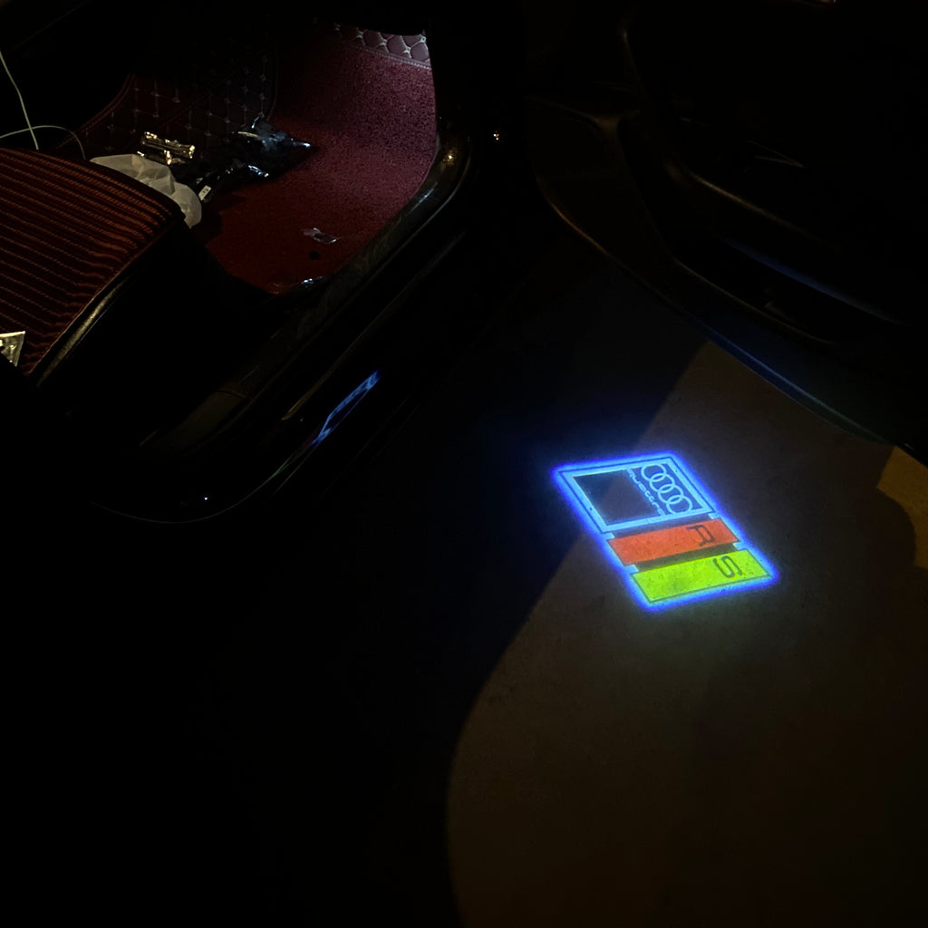 AUDI LOGO PROJECTOT LIGHTS Nr.19 (الكمية 1 = 2 Logo Films /2 أضواء الباب)